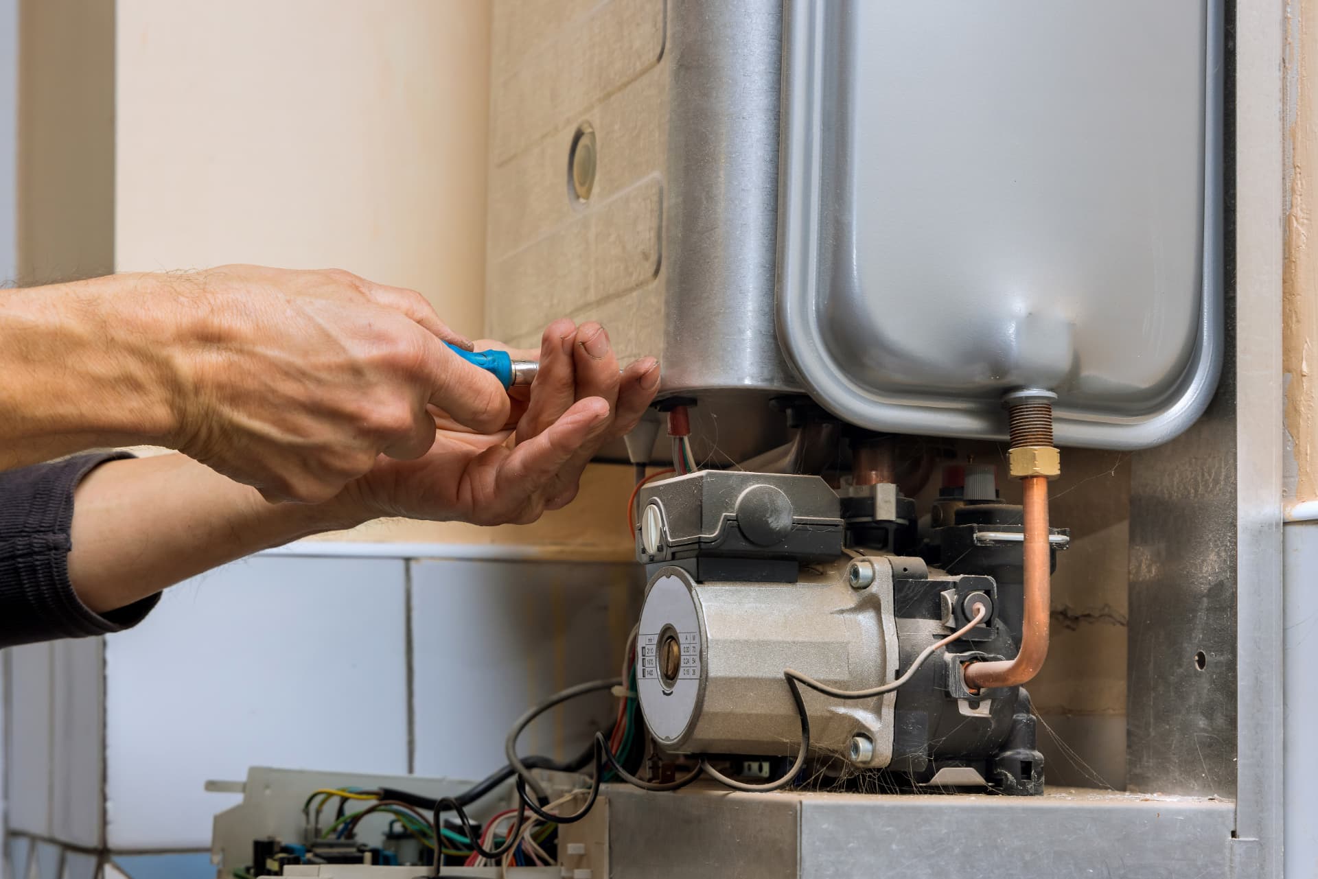 Heating engineer repairing a gas boiler